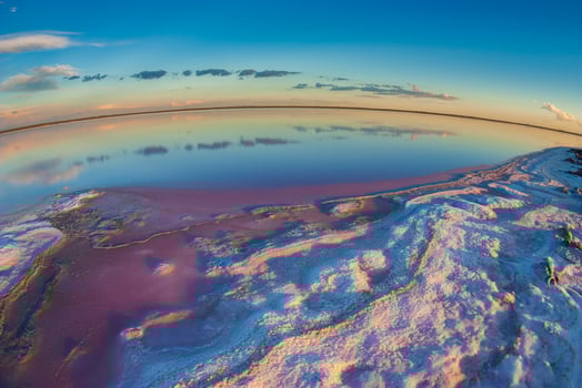 a view of the sky and water from a fish eye lens photo