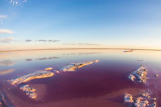 a view of the sky and water from a fish eye lens photo