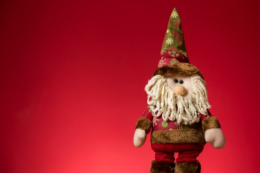 a santa claus doll with a beard and hat photo
