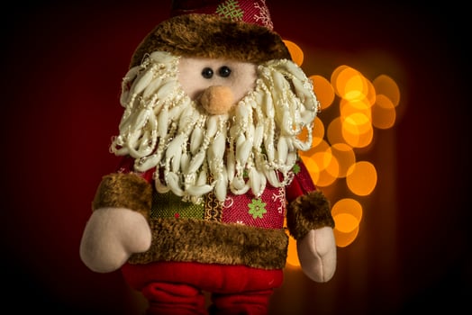 a santa claus doll with a beard and hat photo