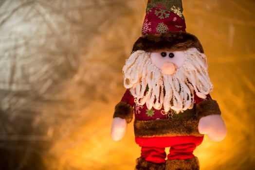 a santa claus doll with a beard and hat photo