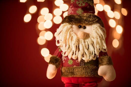 a santa claus doll with a beard and hat photo