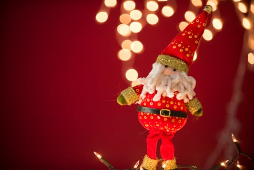 two santa claus and gnomes on a red background photo