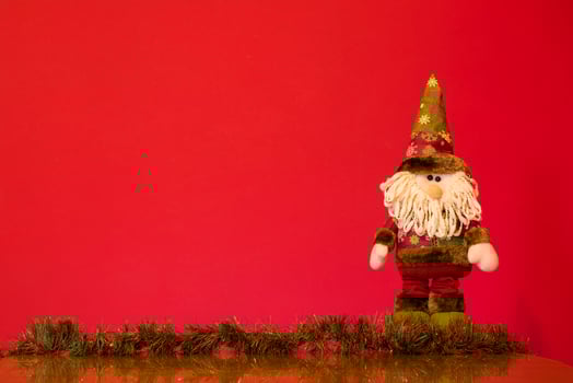 a santa claus doll with a beard and hat photo