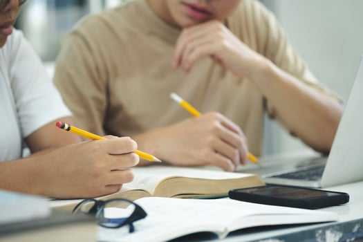 Young students campus helps friend catching up and learning. photo