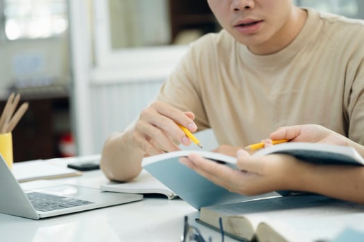 Young students campus helps friend catching up and learning. photo
