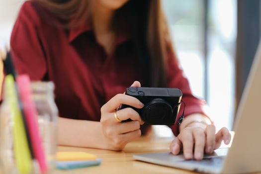 Photo artist and graphic desginer selecting pictures from camera.