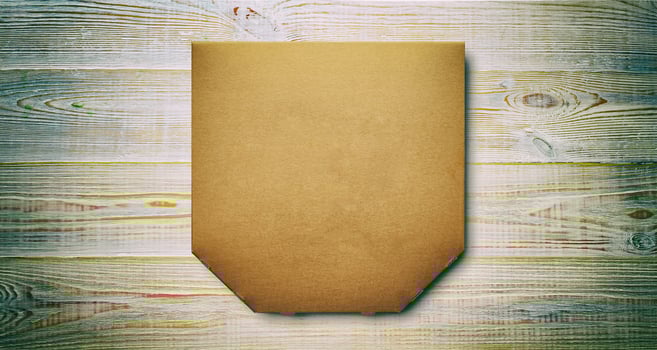 Box of cardboard pizza, blank unprinted on wooden background, mockup top view photo