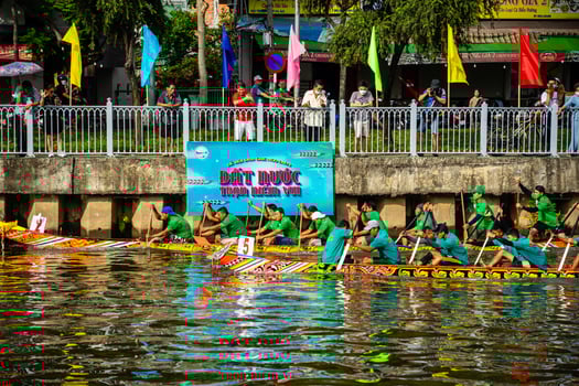 Ho Chi Minh, Viet Nam - 23 April 2023 Blurry motion of boat racing in the traditional Ngo boat racing festival of Khmer people photo