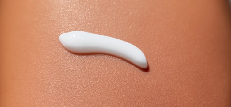 Close up of Sunscreen Protection or Sun Cream on human skin. photo