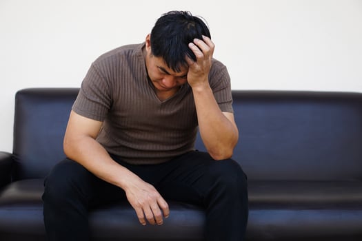 Asian man feels sad, stressed, depressed, hands covered his head. Concept, drepression, failure, disappointment, broken heart. guilty,finances crisis. Life problems. photo