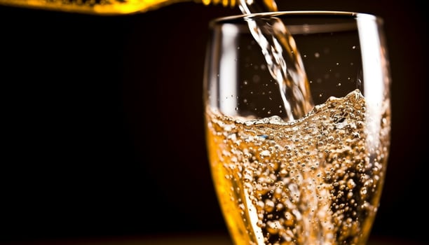 Golden liquid flowing, splashing in glass, celebrating fresh refreshment generated by AI photo