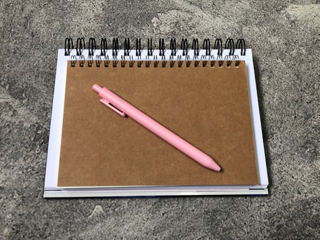 School books, office stationery, gray background photo