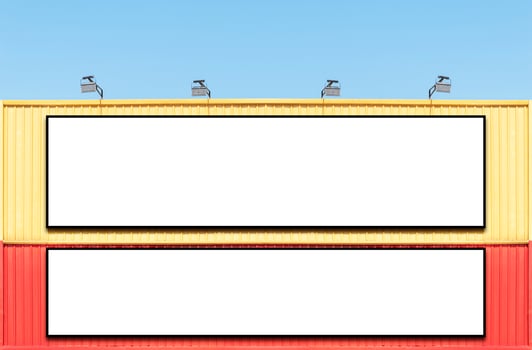 Two billboard white background  on yellow and red building with spot light photo