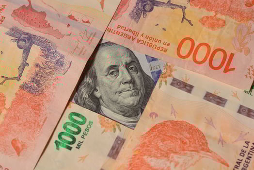 New Argentine banknotes and US dollar bills photo