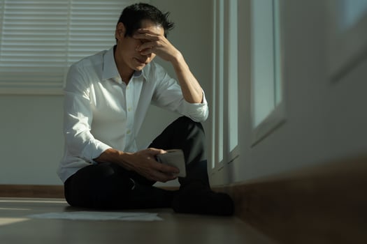 Stressed and headache asian man with large bills or invoices no money to pay to expenses and credit card debt. shortage, Financial problems, mortgage, loan, bankruptcy, bankrupt, poor, empty wallet photo