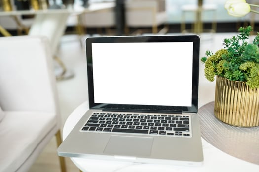 Laptop with Mock up blank screen on table in front of cafe space for text. product display computer laptop montage- technology concept photo