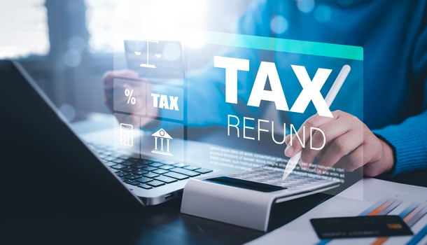 Concept of tax payment optimisation business finance,Man using calculator and taxes icon on technology screen,income tax and property, background for business, individuals and corporations such as VAT photo