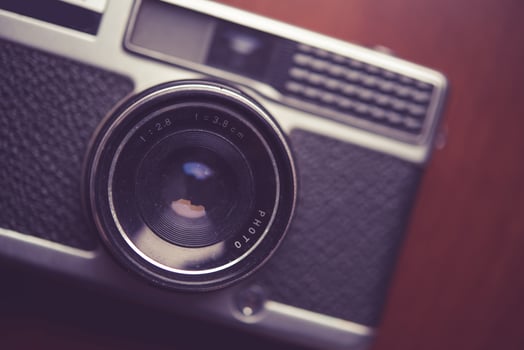 Retro camera on wood table background photo