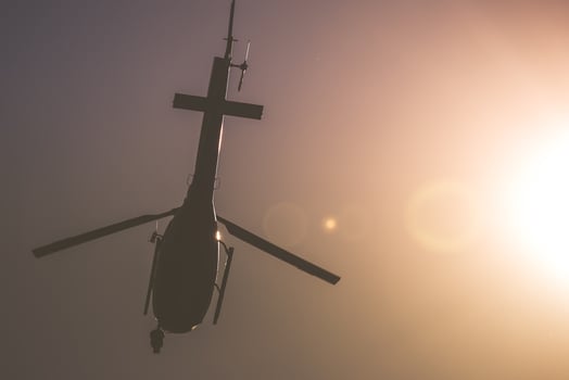 Helicopter in the Air with Sunlit Sky Background photo