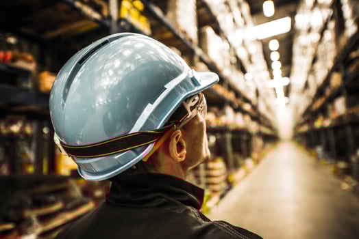 Modern Warehouse Worker in Safety Helmet and Goggles photo