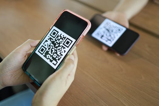 Qr code payment. Woman scanning QR code online shopping cashless technology concept. photo