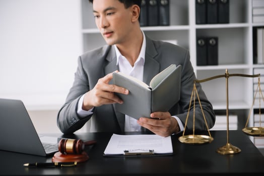 justice and law concept.Male judge in a courtroom on wooden table and Counselor or Male lawyer working in office. photo