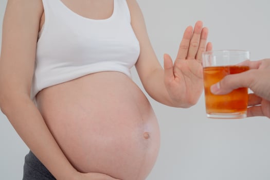 Pregnant woman rejecting and say no alcohol or liqueur during pregnancy, stop gesture, refuses , confuse, prevent disabilities or disorders in baby, healthy of life and caring about health of baby photo