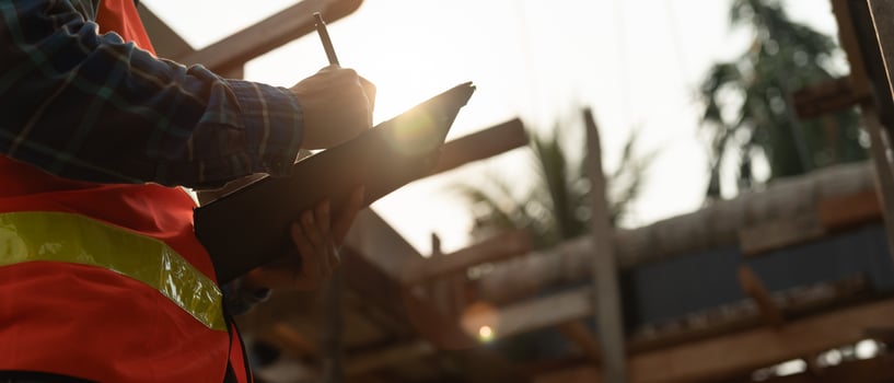 inspector or engineer is inspecting construction and quality assurance new house using a checklist. Engineers or architects or contactor work to build the house before handing it over to the homeowner photo