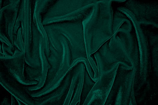 Green velvet fabric texture used as background. Peacock color panne fabric background of soft and smooth textile material. crushed velvet .luxury emerald tone for silk. photo