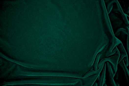 Green velvet fabric texture used as background. Peacock color panne fabric background of soft and smooth textile material. crushed velvet .luxury emerald tone for silk. photo