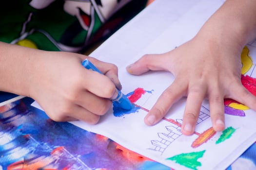 kid hand with coloring pencil. drawing activity photo