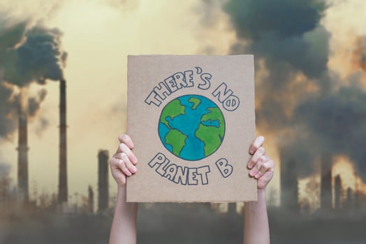 Climate change manifestation poster on an industrial fossil fuel burning background. There is no planet b photo
