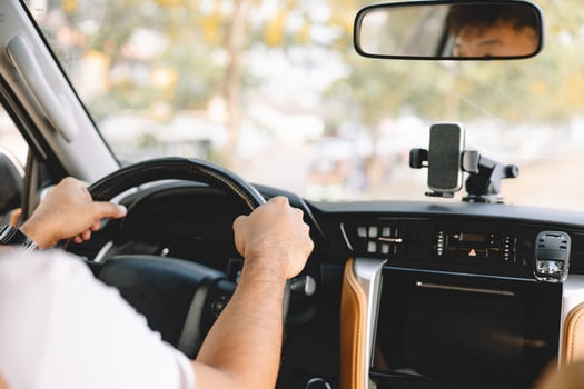 Asian man driving and looking straight while driving a car. Driving car concept. photo