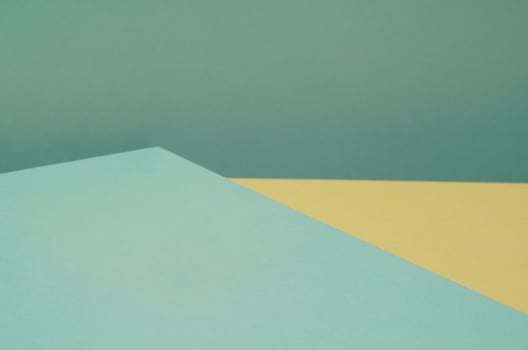 Colorful background from green and yellow paper with shadow. Abstract geometric photo