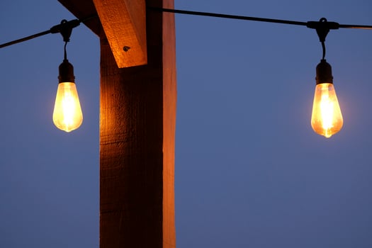 Light bulb against a dark sky at nightfall photo
