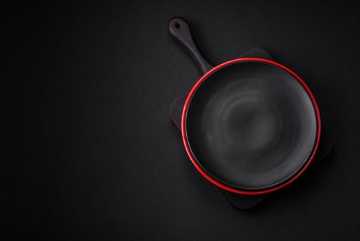 Empty ceramic plate on dark textured concrete background photo