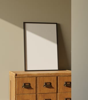 black wooden frame mockup standing on the wooden drawer leaning on the green wall lit by sunlight photo