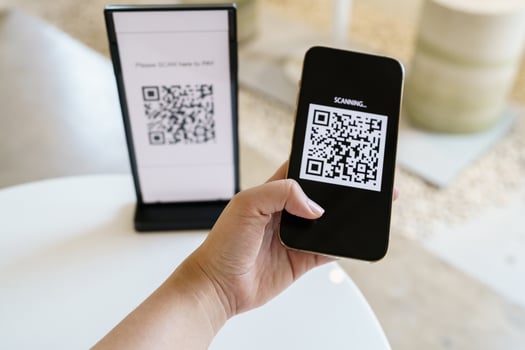 Qr code payment. E wallet. Man scanning tag accepted generate digital pay without money.scanning QR code online shopping cashless payment and verification technology concept. photo