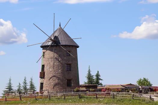 Windmill and blue sky. Photo of windmill with harvests