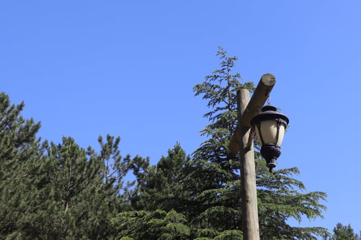 Old wooden lanterns hanging on a wooden pole. photo