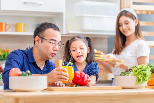 Father mother and daughter cooking together in the kitchen, Happy Asian family concepts photo
