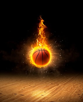 basketball on fire, a dark background on a hardwood gym floor photo