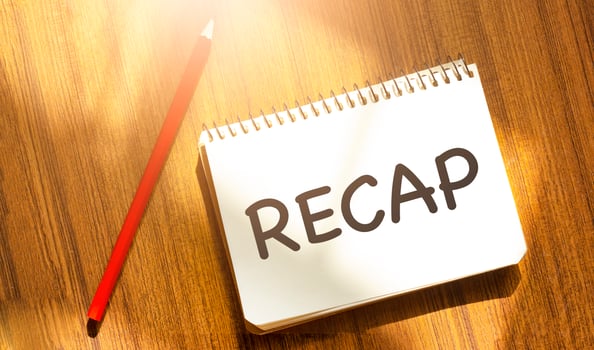RECAP on yellow notebook with red marker and wooden background photo