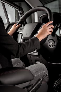 young millennial woman doing test drive in a new car with minimal concept photo