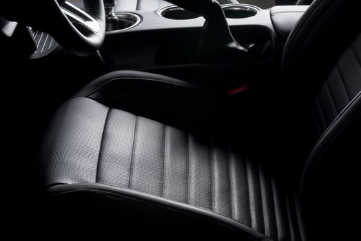 Black leather seat for driver inside a sports car, luxurious details. photo