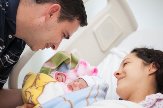 Young mother and father with their newborn baby girl at the hospital on the day of her birth. Family concept. Parenthood concept photo