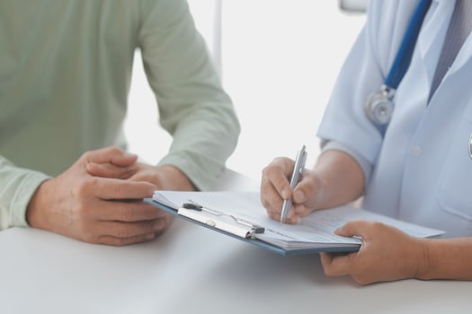 Young doctor visiting elderly woman at home photo