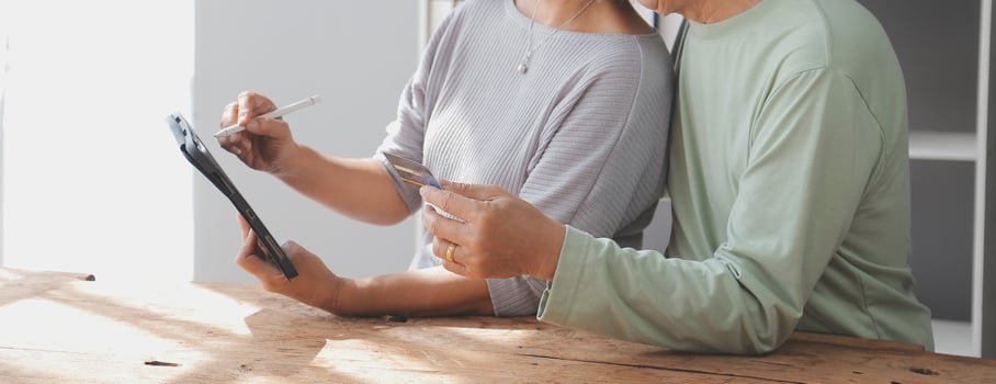 Close up mature man holding plastic credit card, senior couple family paying online, using laptop, satisfied older customers making secure internet payment, shopping, browsing banking service photo