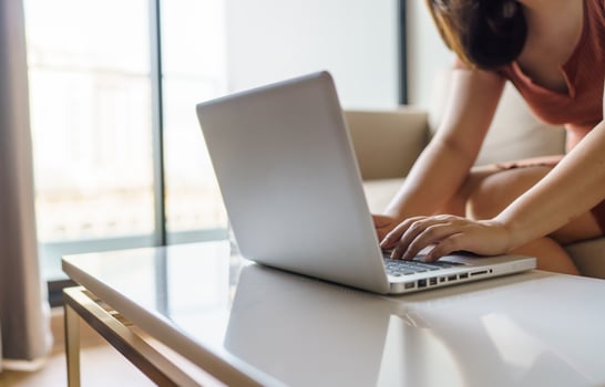 woman using computer laptop for work online at living room. photo